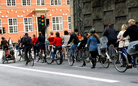 A group of people cycle commuting