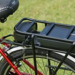A black e-bike battery on a red bike frame.